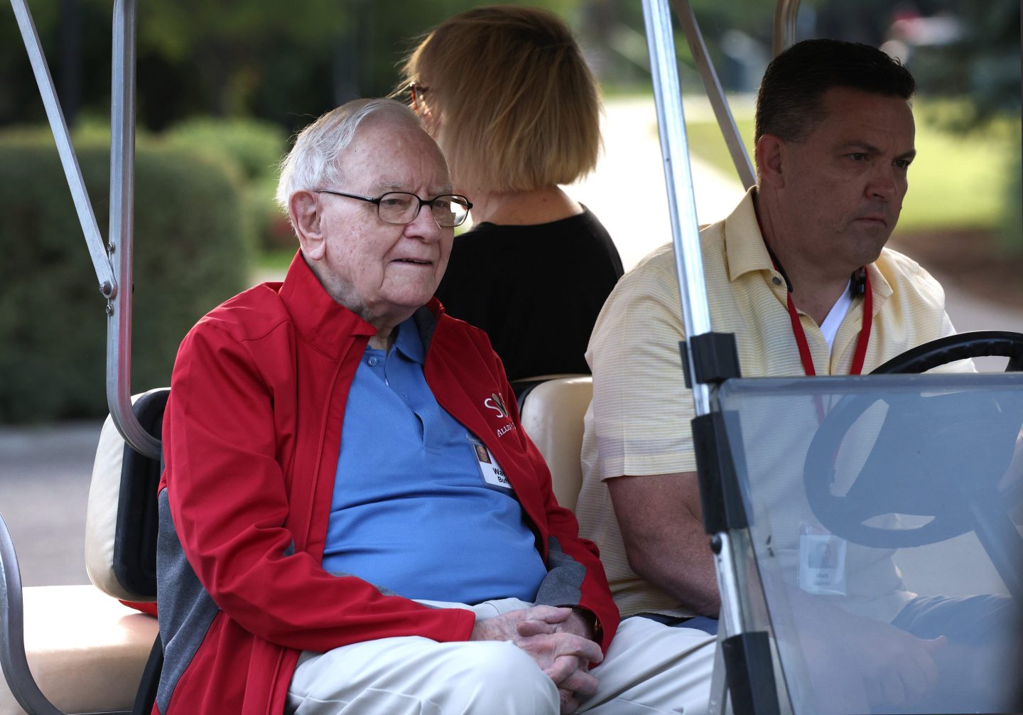 Chairman and CEO of Berkshire Hathaway Warren Buffett rides in a golf cart.